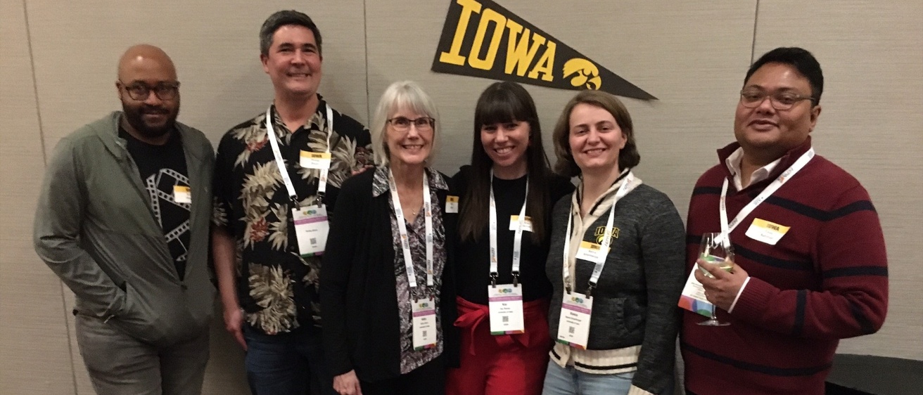Students and facutly standing together at AERA 2025